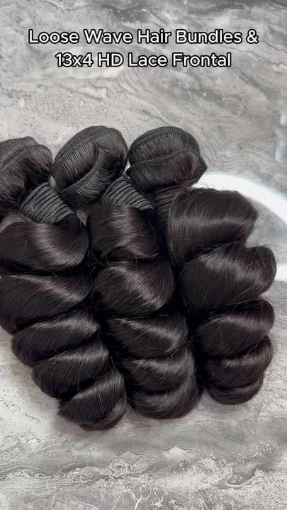 Loose Wave Brazilian 100% Virgin Hair Bundles (12-40 in) in dark black, neatly arranged.