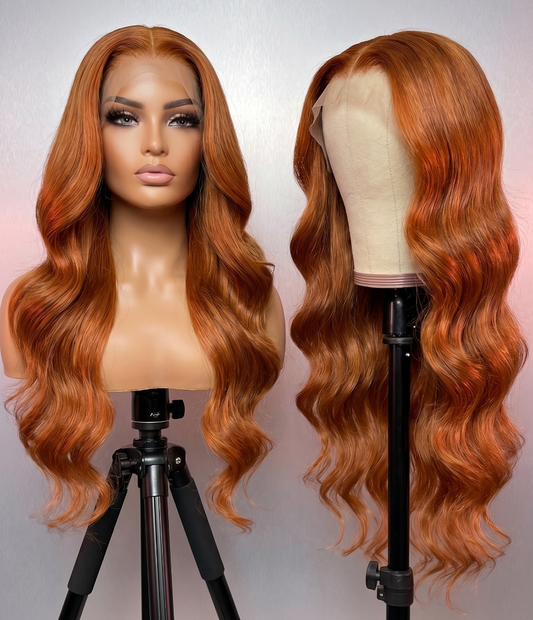 Celebrity Hair & Beauty body wave wig with 13x6 HD lace, orange/ginger color, 210% density extensions on a mannequin head.